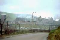 Taken in July 1964. I remember the taste of sulphur in my mouth as I cycled past! The view is looking north west and shows the Victoria Steelworks, the southern part of the Ebbw Vale Steelworks complex. The building to the left still stands and Ebbw Vale Parkway station is now located in the cutting to the left.<br><br>[John Thorn /07/1964]