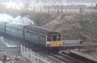 Having paused while Manchester Bury electric trains passed [See image 21454] the six car DMU forming the <I>Rossendale Farewell</I> railtour draws forward over the flat crossing to continue to Bury Bolton St and the Rawtenstall branch on 140281. The remains of the Knowsley St platform can be clearly seen. This view has changed completely with the construction of the ELR <I>ski jump</I> bridge carrying trains over what are now Metrolink tracks. <br><br>[Mark Bartlett 14/02/1981]