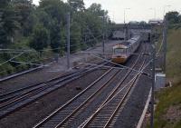 Craigentinny Junction is where the west connection is made between Craigentinny Depot and the ECML. A westbound 125 is shown passing under the wires in 1989. The Moira Terrace bridges over the line give away that the line was formerly four tracks. Four tracks between Waverley and Portobello Jnct would be very useful today with the extra new trains from Edinburgh to Tweedbank. Perhaps the route via Abbeyhill and Lochend will see passenger trains again one day.<br><br>[Ewan Crawford 12/06/1989]