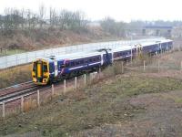 Running through Newcraighall South Junction onto the single line section on 22 January 2017 is the rainsoaked ScotRail 0945 Tweedbank - Edinburgh Waverley. The train is slowing for its next stop at Newcraighall station, located on the other side of the bridge carrying Whitehill Road. Running along the top left of the picture, just beyond the tree line, is the road that now links the the Biogen anaerobic digestion facility, opened last year, with Whitehill Road. [See image 51265]<br><br>[John Furnevel 22/01/2017]