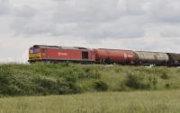 60039 heads westbound on the GWML near the village of Longcot. To the east of Swindon. This is the Theale to Robeston oil tanks. Passing time, 1455 hours.<br><br>[Peter Todd 30/06/2016]