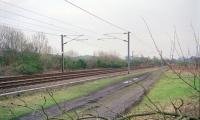 View south at Dalry Junction from the site of Dalry No 3 box, south of Dalry station. There was a short lived Dalry Junction station here (1850 to 1860). The Kilmarnock and Ayr routes separated here and ran a short distance south before diverging. This was on the quadruple section to Kilwinning which started at Brownhill Junction (or, arguably, St Enochs). The box also served a number of colliery branches.<br>
<br>
Donald Hillier comments 'The 4 track section from Brownhill used to go as far as Kilwinning around WW2 then reduced to 2 tracks as far as Dalgarven, then it was (at that time) the Up Goods, Up Main and Down Main to/from Kilwinning before finally being reduced to 2 tracks when Dalgarven SB closed 24 Mar 1968.'<br><br>[Ewan Crawford //1997]