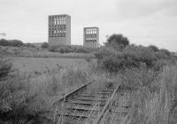 The skeletal winding towers of Rothes Colliery, closed in 1962 and demolished in 1993.  In the foreground is the direct BR connection with the main line on the extreme right.  To the left is the embankment of the link to Thornton Yard.<br><br>[Bill Roberton //1992]
