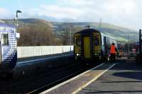 The driver of the 13.57 from Stranraer (for Kilmarnock) hands over the token to the signalman while the 13.59 to Stranraer waits for it to be handed over to its driver.<br>
A bit of the past with the bells sounding in the box.<br><br>[Colin Miller 08/02/2017]