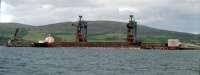 Iron ore carrier 'Enterprise' at Hunterston Pier in 1989. This facility allowed import of iron ore and coal for the Ravenscraig Steelworks and replaced General Terminus in Glasgow. Since closure of the steelworks it has been used to import coal for power stations.<br><br>[Ewan Crawford //1989]