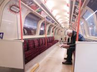 A fellow passenger catches up with the scandal (before realising it's his stop) while the train catches up time at Govan Subway on 11/02/2017. In a hark-back to a previous era there is no visual travel information, and the next station stops are announced briskly by the driver.<br><br>[David Panton 11/02/2017]