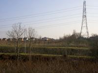 View from the location of the west abutment of the Glasgow, Bothwell, Hamilton and Coatbridge Railway bridge over Daldowie Road towards the site of Broomhouse station. The deep cutting in the foreground is the 2016 realignment of Daldowie Road. The railway solum continues east from the Broomhouse station site passing to the right of the new housing in the centre of the photograph.  <br><br>[Colin McDonald 14/02/2017]