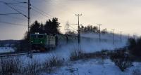ASEA RC 4 loco of Green Cargo, the SJ freight subsidiary, hauls the empty aviation fuel tank train at -17 degrees Celsius. It also raised an enveloping cloud of powdery snow as it passed. The embankment of the original alignment   is visible to the right of and parallel to the replacement 2 tracks.<br><br>[Charlie Niven 05/01/2017]