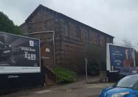 Lochee station's former Newtyle bound platform building seen between the billboards.<br><br>[John Yellowlees 22/02/2017]