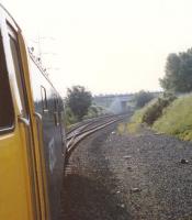 Due to track lowering in Haymarket Tunnel prior to eletrification, West Coast trains were diverted around the South Sub. Here a Waverley to Birmingham train had left the East Coast Main line at Portobello East Junction and is about take the right hand track to gain the (poorly maintained) Up and Down Suburban. The bridge is OB1 Sir Harry Lauder Road.<br><br>[Charlie Niven /07/1989]