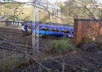  View north west, from the trackbed of the former Glasgow, Bothwell, Hamilton and Coatbridge line, across Uddingston Junction at the point where the GBH&C crossed over the Caledonian's Edinburgh and Glasgow tracks as well as the Clydesdale Section tracks. The train passing is an Edinburgh – Glasgow via Shotts DMU.<br><br>[Colin McDonald 24/02/2017]