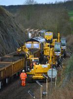Busy scene to the west of Aberdour as a road-rail machine trims the load of spent ballast.  Freightliner 66544 is in the background.<br><br>[Bill Roberton 19/03/2017]