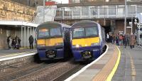 320412 + 320313 pausing at Motherwell on 9 March with 2C06 Milngavie to Cumbernauld. Alongside is 320311 on 2B92 Glasgow Central to Lanark. Unit 320412 is one of the Ex London Midland class 321 4 car EMUs  converted to 3 cars for Scotrail services.<br><br>[Ken Browne 09/03/2017]