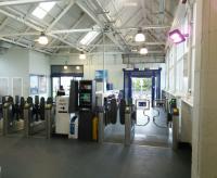 The interim (one can hardly say temporary) entrance to Dundee station, seen from behind the ticket barriers on 15/03/2017. The building which will contain the new entrance takes shape on the eastern side, replacing the one that looks like it was made of plastic.<br><br>[David Panton 15/03/2017]