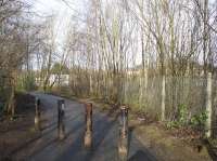 View north west at the point where the public footpath turns left off the trackbed of the GBH&C and instead runs parallel to the still operational tracks of the Clydesdale Junction Railway at Uddingston junction. Straight ahead is the point where the GBH&C crossed the tracks of Uddingston junction on a long removed bridge [see image 58391].<br><br>[Colin McDonald 24/02/2017]