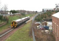 The 0945 (Sunday) ex-Tweedbank slows for the Newtongrange stop during a wet and blustery morning on 19 March 2017. The building on the right once served as the NCB Lady Victoria Colliery locomotive shed [see image 6114].<br><br>[John Furnevel 18/03/2017]