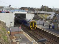 158704 forming the 1018 service to Glasgow Central passes under the partly constructed replacement Station Road overbridge. The temporary bridge for pedestrians and services can be seen above the concrete abutment panels on the left of the photo. Access by kind permission of Abellio ScotRail.<br><br>[Colin McDonald 24/03/2017]