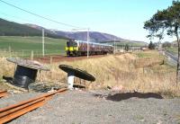 The 1109 First TransPennine Glasgow Central - Manchester Airport runs parallel with the A702 between Lamington and Abington past a Network Rail access point on 27 March 2017. <br><br>[John Furnevel 27/03/2017]