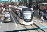 An Edinburgh tram stands at the current city terminus in York Place on 24 March 2017 ready to form the next service to Edinburgh Airport. View from the top deck of a bus, with Leith Walk straight ahead. The case for extension of the network south, in line with the original plans, is currently under debate. [See image 16868]<br><br>[John Furnevel 24/03/2017]