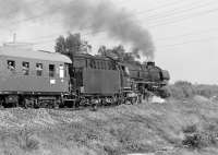 012 080 forges north at Hanekenfaehre with train D1731 Muenster to Norddeeich Mole, which was booked to depart Rheine at 09:12. This was the last Saturday of the summer service and the last occasion on which this train was steam-hauled, hence the grocers at the windows of the leading coach. The cooling tower and chimney in the left background belong to Lingen nuclear power station. 7th September 1974<br><br>[Bill Jamieson 07/09/1974]