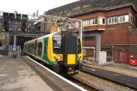 A London Midland service from Birmingham exits the tunnel, passes the signalbox and enters the station at Liverpool Lime Street on 12 March 2015.<br><br>[John McIntyre 12/03/2015]