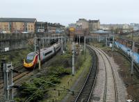 The site of Eglinton Street station looking south as a Virgin Pendolino passes on the final mile to Glasgow Central.<br><br>[David Panton 01/04/2017]