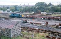 Shettleston Yard was in use as an extensive PW depot in 1988. The yard was formerly associated with various local works such as the Mount Vernon Iron Works. It was located east of Shettleston Junction. Here 26027 shunts a short PW train. The site is now overgrown, trackless (except for the electrified lines) and derelict.<br><br>[Ewan Crawford //1988]