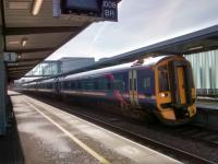 A 4-coach 158 for Inverness calls and picks up the passenger, a little old lady. Just in shot is the bridge repeater for the signal at Maybury. This is a new (to me) sort that shows clear in green, but perhaps oddly the other aspect is still white. Photographed 26/03/2017.<br><br>[David Panton 26/03/2017]