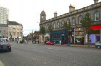 The Foot of  the  Walk on 14 September 2006, with the station clock above the former Leith Central  (closed 1952) showing the time as a few minutes before noon.  Straight ahead is Constitution Street and the road to the docks. Rounding off the picture centre left is Queen Victoria (God bless Her) standing in front of Woolworths.<br><br>[John Furnevel 14/09/2006]