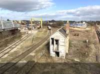 View east from New Elgin Road bridge on the afternoon of 4 April 2017.  The former Elgin East station stands on the left, with the main Inverness – Aberdeen line on the right disappearing towards Keith. (Elgin station is behind the camera on the west side of the bridge.)  The abandoned Elgin East signal box still survives in the centre, while beyond the gantry crane two class 66 locomotives are stabled with a PW train. A line of wagons loaded with new track panels stands in the sidings.<br><br>[Andy Furnevel 04/04/2017]