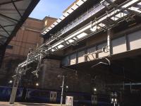 The OHLE gantry with the isolation switches at the station throat blends well with the Modernist look of the Buchanan Galleries car park link corridor. <br><br>[Colin McDonald 08/04/2017]