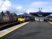 A Cumbernauld service starts it's journey from Platform 3 at Dumbarton Central on 01/04/2017. To the left Dumbarton Municipal Buildings undergo restoration.<br><br>[David Panton 01/04/2017]