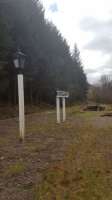 Lamp and station sign on the island platform at Invergarry. The view looks to Spean Bridge and the pedestrian exit ramp is seen at the end of the platform.<br><br>[John Yellowlees 02/04/2017]