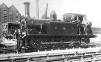 An unidentified NB 'R' class 0-6-0T (later LNER Class J82) at Langholm, thought to have been taken in the early years of the 20th century. Langholm station is just off picture to the right, while the building in the background is Waverley Mills. [Ref query 993] <br><br>[Bruce McCartney Collection //]