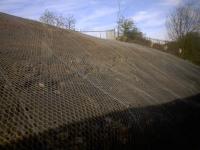 The netting season - a quick grab shot of the repairs to the embankment which collapsed in April 2017 taken from a passing Fort William train.<br><br>[Colin McDonald 12/04/2017]