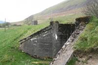 Remains of the Talla Railway looking south towards Tweedsmuir from the car park of the Crook Inn on 25 April 2009. The long gone wooden platform stood alongside the base of the old water tower in the background. [See image 23860]  <br><br>[John Furnevel 25/04/2009]