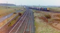 Looking south from Craigend (formerly Fullarton) Road overbridge along the Troon avoiding line to Lochgreen Junction, 29 October, 1982, Class 20 No 20179 swinging onto the Troon loop with a northbound freight. The junction had been reduced to a single lead with facing crossover circa 1973 (I believe) and was taken out completely not long afterwards as the Troon avoiding line closed, Saturday, 27 November, 1982.<br><br>[Robert Blane 29/10/1982]