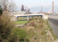 The line from Port Talbot Harbour to the main line as can be seen it has not been used a number of years, probably since steelmaking ceased at Llanwern in 2001. <br>
<br>
Curiously, when they built the new distributor road they had to build a temporary entrance to the work and they lifted a section of track and the embankment to allow vehicle access while that new over bridge was built. They then replaced the embankment and relaid the track but as far as I know there has never been a train down there. The relaid section is just the other side of the bridge just after the magnet.<br><br>[Alastair McLellan 03/04/2017]