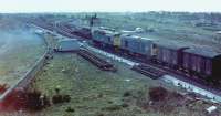 Looking south from the road overbridge at Barassie Junction, Monday, 29 November, 1982, the line straight ahead is the Troon avoiding line, closed Saturday, 27 November to allow the alterations to the junction to be completed. The new double track deviation, joggled behind the Signalbox (itself officially closed the day before and already being demolished), had opened that morning and would be slewed across onto its final and faired up  alignment, next weekend I think it was, after demolition of the 'box was completed. The southbound line onto the Troon loop was retained as a loop off the main line, the former junction points becoming the access to Barassie run-round loop and yard. Note also that the connection of the deviation to the Troon loop at its south end took out the connection to the sidings on the old K&TR alignment, these lifted soon afterwards as part of the general tidying up process around the junction.<br><br>[Robert Blane 29/11/1982]