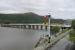 The lower quadrant signals at Penmaenpool are a nice reminder that the hotel access road in the foreground occupies the old GWR trackbed. This view looks east with the old station site just out of sight beyond the bridge toll house. The wooden toll bridge over the Mawddach Estuary still carries road traffic.  <br><br>[Mark Bartlett 19/09/2016]