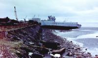 The hulk of ex-French Navy 'Sirius' Class minesweeper 'Vega' (P707) photographed beached on the east (North Shore) side of the East Pier at Troon Harbour, 26 November, 1982. The partially demolished vessel had been deliberately beached by the Shipbreakers on that side of the pier in the usual way in preparation for final breaking but had been blown further ashore and slewed round during a recent storm. 'Vega' and her sister 'Sagittaire' (P743) had arrived at Troon under tow of the Frank Pierce tug, 'Pullwell Lima', 22 April, 1982 (other sources quote 01 April as the arrival date for both vessels) and they lay at the East Pier for several months before breaking started as there were other vessels being dealt with first.<br><br>[Robert Blane 26/11/1982]