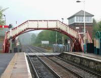 A misty morning in the Tyne Valley at Prudhoe on 7 May 2006. Platform view west over Station Road level crossing, looking towards Hexham and Carlisle.<br><br>[John Furnevel 07/05/2006]