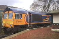 66737 with a load of alumina powder wagons waits in the loop for the 0821 ex Glasgow Queen Street passenger service for Fort William and Mallaig to clear the points before moving off. <br><br>[Colin McDonald 12/04/2017]