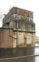 The old surviving water tower at Hexham, standing alongside the site of the former locomotive shed, just to the east of the station. Photographed looking north towards the running lines on a wet day in May 2006. [Ref query 1002] <br><br>[John Furnevel 10/05/2006]