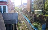 The rusting tracks of the Powderhall branch, looking south east from Powderhall Road towards Leith Walk on 17 April 2017, more than two months after the last 'Binliner' ran. The heavily buttressed wall on the right will be one of many pleased at the cessation in daily vibrations caused by traffic on the branch [see image 13859].  Powderhall depot is due to close completely at the end of 2018 when the new facility at Millerhill comes on stream.<br><br>[Andy Furnevel 17/04/2017]