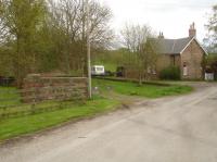 View south showing the site of the level crossing across Luddith Road and the trackbed passing the former North Grimston Station House. The coal drop walls are still extant on the left. There were twin tracks running from south east of the Station House towards the Cordike Lane overbridge to the north west, as a long siding ran parallel to the running line to serve firstly the coal drops then a short spur sited at an angle to Luddith Road to right of view. As the points for the latter were in front of the Station House it effectively gave three tracks running across the road.<br><br>[David Pesterfield 17/04/2017]