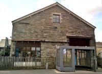 The goods shed at Wadebridge still sports the hangers from the sliding door, as well as an ugly modern bus shelter. View looks towards the station, and Padstow. [see image 17834] [Ref query 1007]<br><br>[Ken Strachan 10/04/2017]