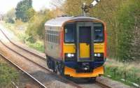 Approaching the level crossing at St James Deeping on the line between Peterborough and Spalding in July 2014 is East Midlands diesel railcar 153357. <br><br>[Ian Dinmore 22/07/2014]