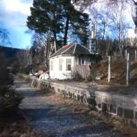 Late winter photo of the former station building in Cambus o'May at that time under conversion to a small private residence. Part of the famous white suspension bridge is just visible in the left background over the trackbed below Culblean Hill. This part of the bridge was removed in 1988 at the same time as the deck was replaced. The Deeside Way was a long time in the future but it was still possible to walk or, with great difficulty, cycle on the full-depth ballast in an easterly direction to Dinnet Station. To the west a footpath/cycleway was already taking shape all the way into Ballater.<br><br>[Charlie Niven /02/1980]