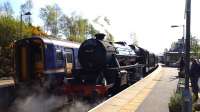 The Jacobite and friend at Glenfinnan. The passengers have not yet alighted as the Jacobite has not yet drawn forward to clear the Fort William end of the station to allow the ScotRail train to leave. After drawing forward the engine is outside the station, which is a shame for those on the train who wish to photograph it.<br><br>[Beth Crawford 02/05/2017]